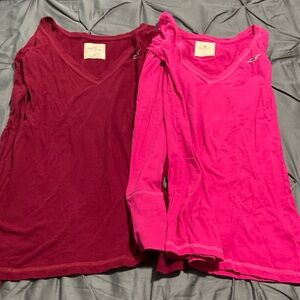 2 Hollister long sleeve shirts. Each are junior size M. Hot pink and a maroon.